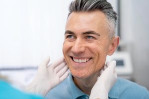 Dentist checking a patient's teeth for a dental bridge in Coal Harbour, Vancouver